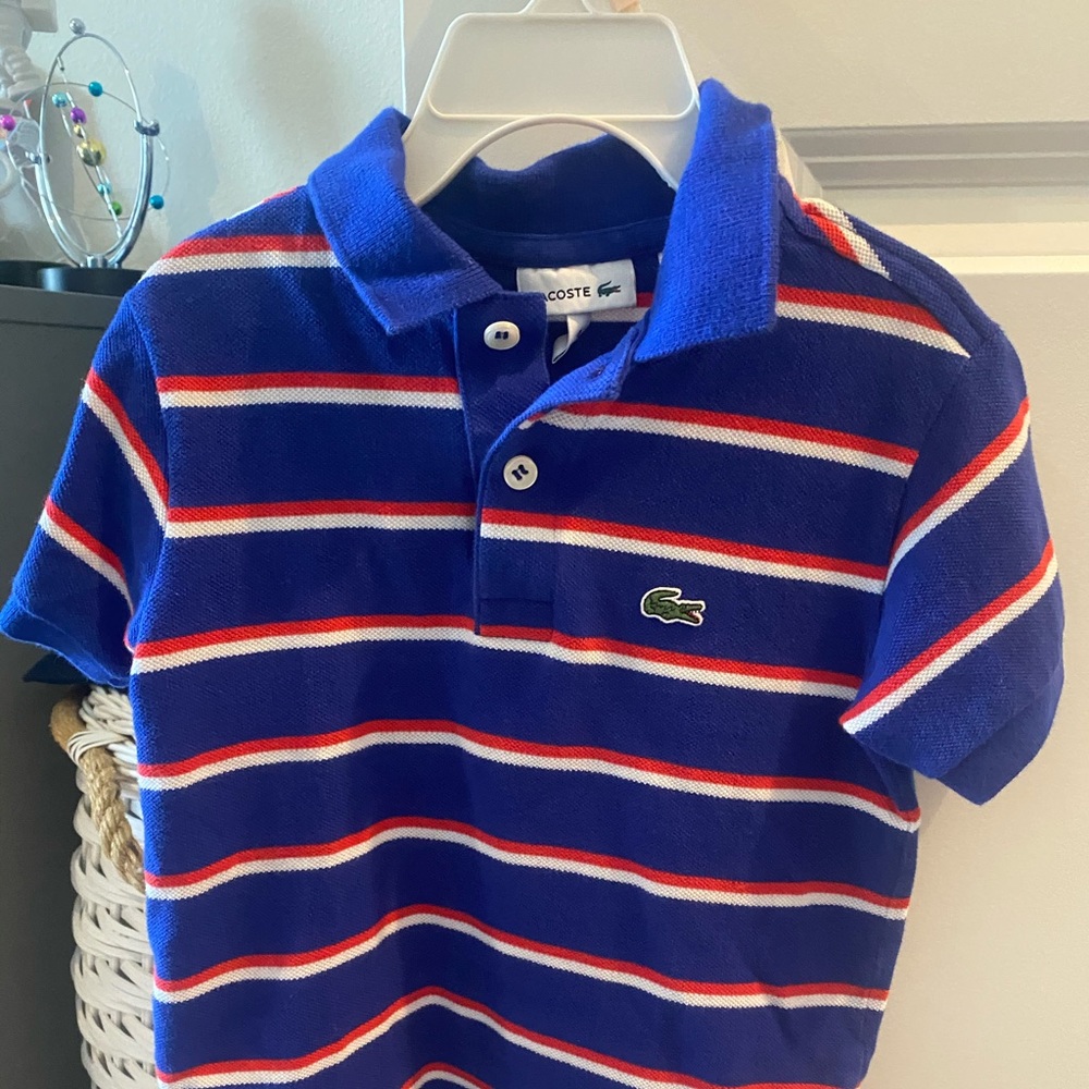 Boys blue with red/white stripes Lacoste polo. 4T